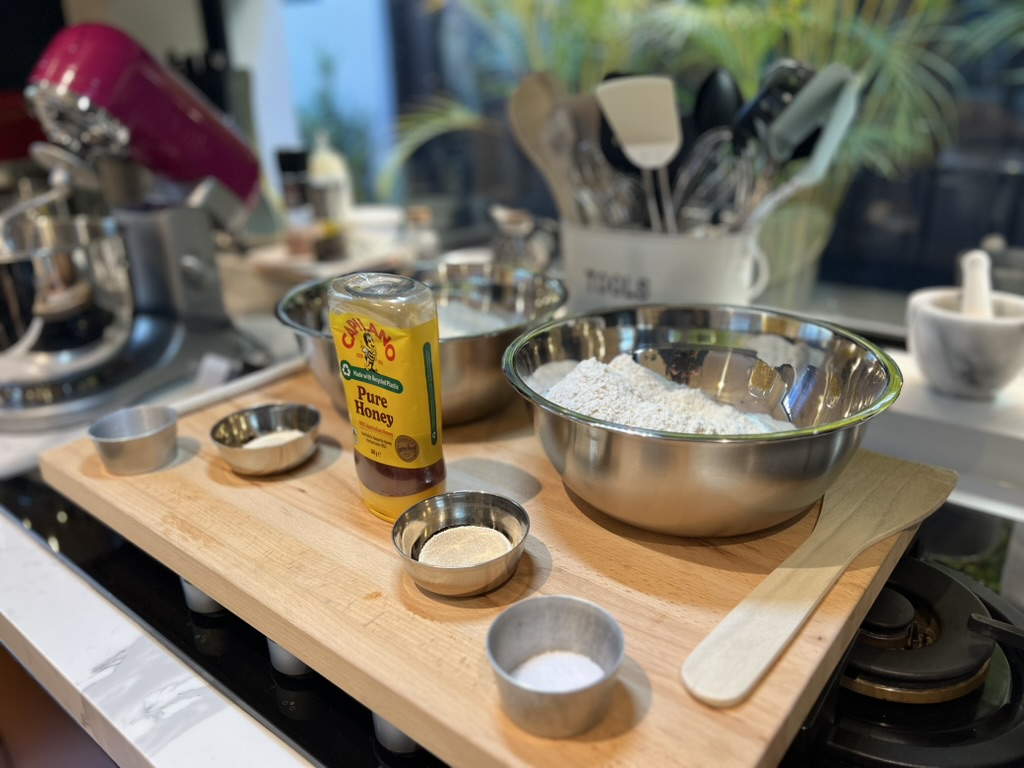 Flour, honey and ingredients laid out before a workshop